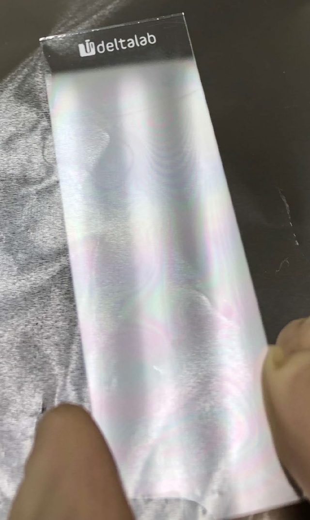 Glass slide coated with 4.7 micrometer parylene film showing rainbow interference pattern