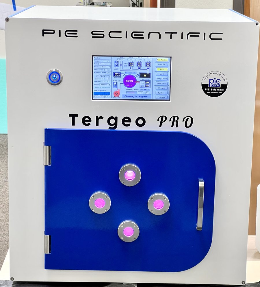 Tergeo-Pro plasma etching system with oxygen plasma glowing behind the four door viewports